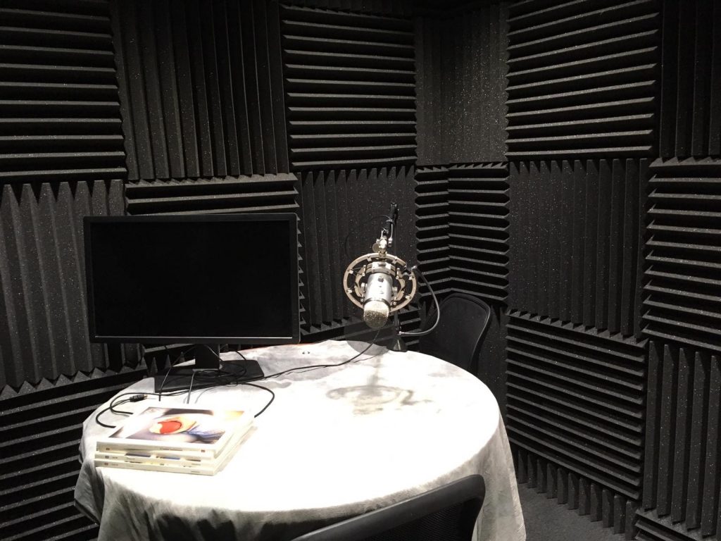 Recording booth with microphone and table