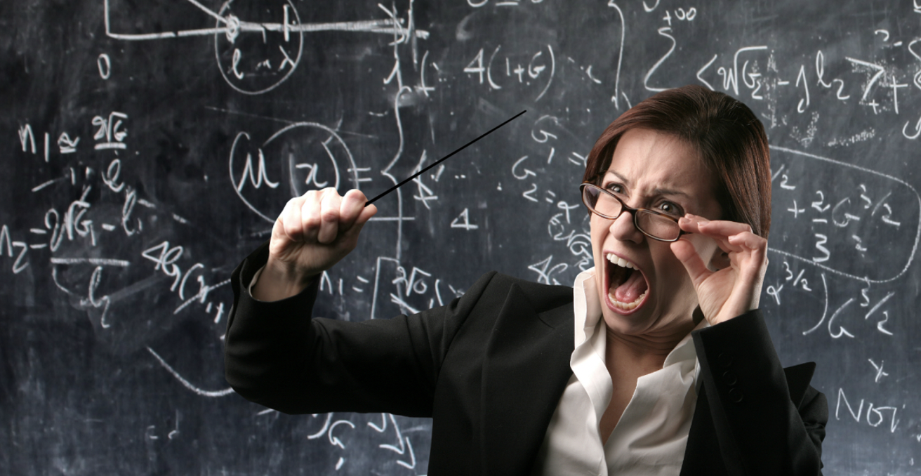 Angry teacher yelling in front of chalkboard